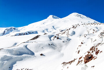 Winter mountains on a sunny day. The top of Elbrus, the Caucasus. - 704543316