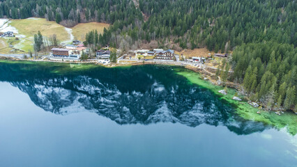 Aerial view over crystal clear water at the Berchtesgaden Hintersee lake and Alps Mountain in...