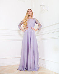 Portrait of the beautiful blond woman in long dress