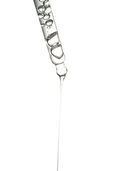 Transparent pipette with serum on an isolated white background.