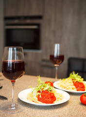Spaghetti with tomato sauce and red wine in a kitchen
