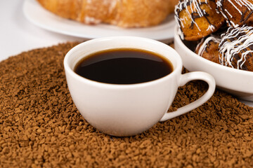A cup of instant coffee granules and scones. Beautiful and delicious breakfast.