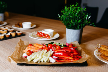 Fresh Vegetable Platter on Dining Table. Colorful array of fresh cut vegetables on a slate board, ideal for healthy eating and buffet spreads.