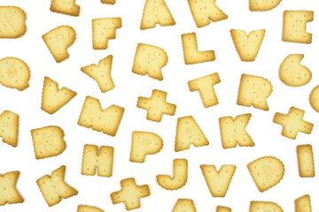 Many letter shaped biscuits isolated on white background. Texture wallpaper