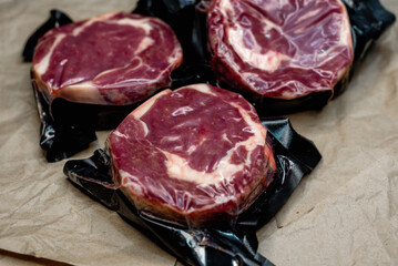 fresh beef in vacuum packaging on a background of kraft paper