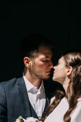 A man and woman kissing. They are outdoors and the woman is holding a flower 5038.