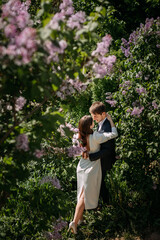 A man and woman kissing in front of a flowering tree 5085.