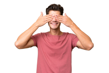 Young handsome caucasian man over isolated background covering eyes by hands