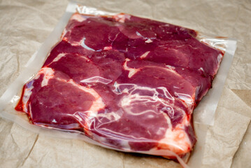 fresh beef in vacuum packaging on a background of kraft paper