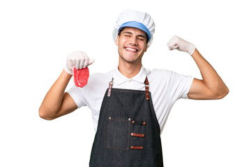 Butcher caucasian man wearing an apron and serving fresh cut meat over isolated background doing strong gesture