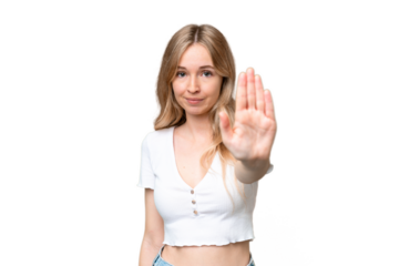Young English woman over isolated background making stop gesture