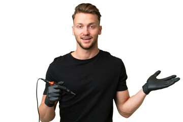 Tattoo artist caucasian man over isolated background with shocked facial expression