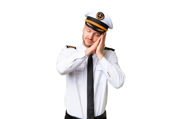 Airplane pilot man over isolated background making sleep gesture in dorable expression