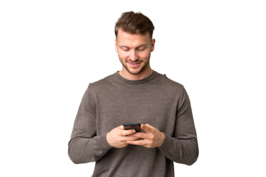 Young handsome caucasian man over isolated chroma key background sending a message with the mobile