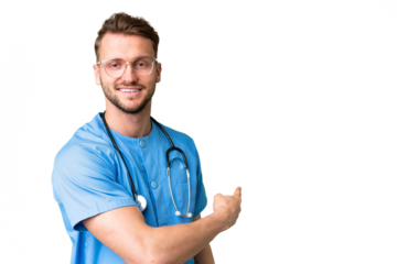 Young nurse man over isolated chroma key background pointing back