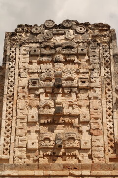 Elaborate decor, faces, masks on the facade of a building in the Cuadrangulo de las Monjas, Quadrangle of the Nuns, Uxmal, Merida, Mexico