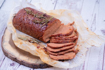 Vegan seitan made out of vital wheat gluten and chikpeas as meat alternative, plant based protein. Cooked, roasted and air fried. Sliced.