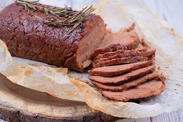 Vegan seitan made out of vital wheat gluten and chikpeas as meat alternative, plant based protein. Cooked, roasted and air fried. Sliced.