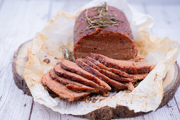 Vegan seitan made out of vital wheat gluten and chikpeas as meat alternative, plant based protein. Cooked, roasted and air fried. Sliced.
