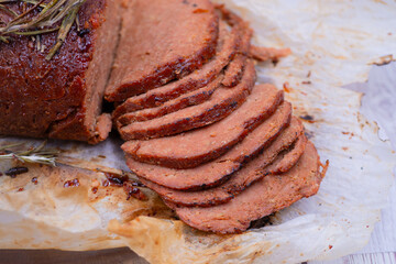 Vegan seitan made out of vital wheat gluten and chikpeas as meat alternative, plant based protein. Cooked, roasted and air fried. Sliced.