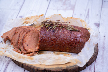 Vegan seitan made out of vital wheat gluten and chikpeas as meat alternative, plant based protein. Cooked, roasted and air fried. Sliced.