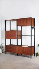 Vintage walnut and black steel wall unit. Iconic 1960s floating cabinets on a steel frame design. 
