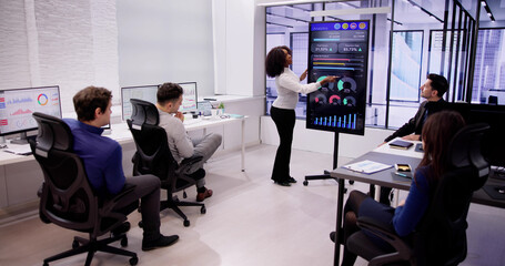 Diverse Team Meeting With TV Screen
