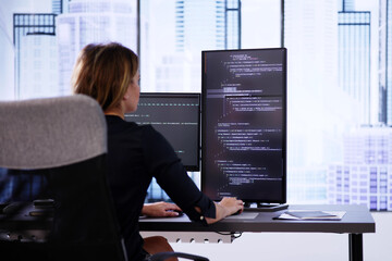 Coder Using Computer At Desk