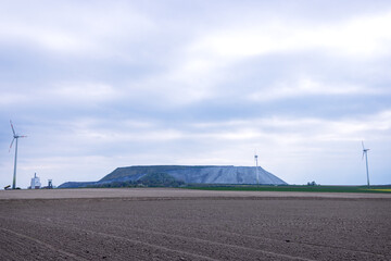 Waste rock dump in a plowed and sown field. Potassium extraction