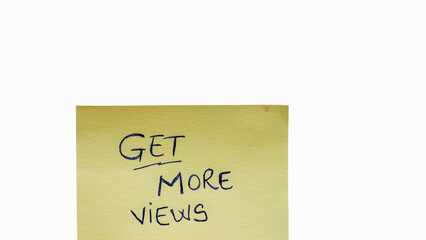 Get more views handwriting text close up isolated on yellow paper with copy space.