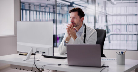 Shocked Mature Male Doctor Looking Computer
