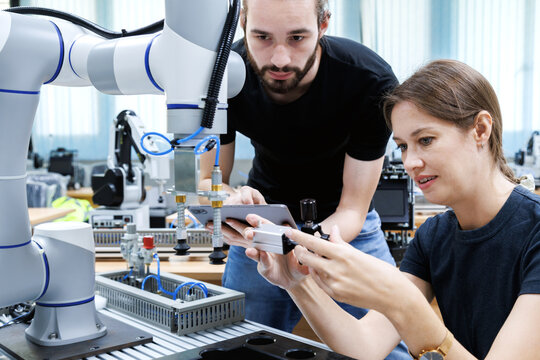automation machine engineer students study and inspection control robot arm machine in robotics engineering academy at university or factory workshop. AI robot technology, future innovation trend.