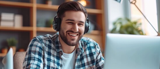 Communication and contact can be made through a call center using laptop video calls with a happy man talking. This can be used for telemarketing sales pitch, e-commerce call center, or online webinar - obrazy, fototapety, plakaty