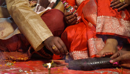 Closeup of indian hindu couple holding each other hands during marriage symbolizing love...