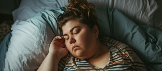 Fototapeta na wymiar Sad overweight woman in bed, pondering-alone.