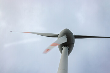 Wind turbine with blades against the sky close-up