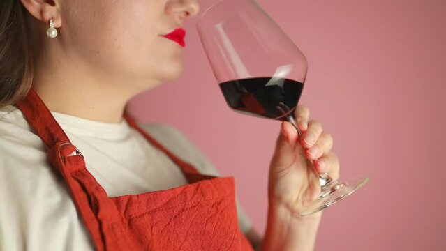 Luxury gorgeous woman drinking red wine at wine tasting event, drink and enjoying testing the quality of a popular blend. High quality FullHD footage
