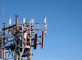 Support for mobile phone antennas and repeaters with blue sky on the right