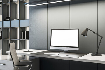 Modern home office with bookshelf and computer on gray wall background. 3D Rendering
