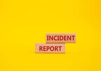 Incident Report symbol. Concept word Incident Report on wooden blocks. Beautiful yellow background....