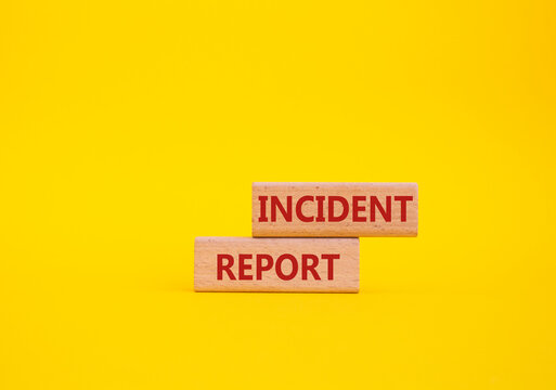 Incident Report symbol. Concept word Incident Report on wooden blocks. Beautiful yellow background. Business and Incident Report concept. Copy space