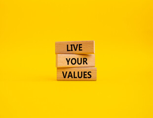 Live your values symbol. Concept words Live your values on wooden blocks. Beautiful yellow background. Business and Live your values concept. Copy space.