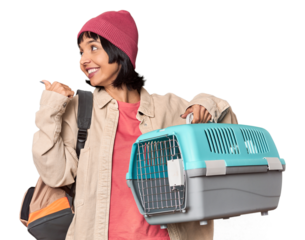 Young Hispanic woman ready for travel with pet carrier pointing with finger at you as if inviting come closer.