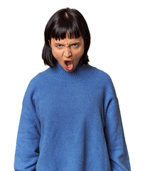 Young Hispanic woman with short black hair in studio shouting very angry, rage concept, frustrated.