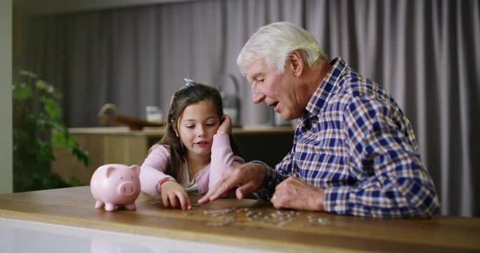 Piggy bank, education or wealth with a girl and her grandfather learning about money, finance or savings. Family, counting and talking with a senior man teaching his grandchild about future budget