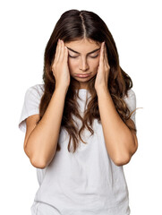 Fototapeta premium Young Caucasian woman in studio setting touching temples and having headache.