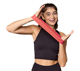 Caucasian athlete exercising with resistance band in studio