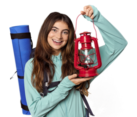 Caucasian woman with mountain gear holding lantern