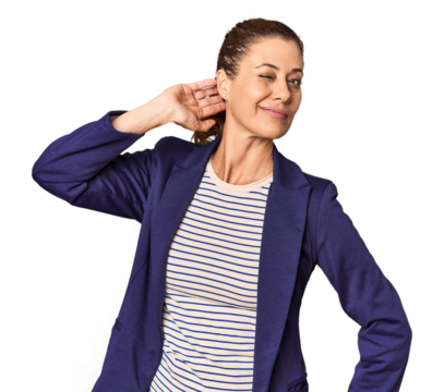 Middle-aged female entrepreneur in studio touching back of head, thinking and making a choice. - Powered by Adobe