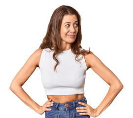 Middle-aged woman portrait in studio setting confused, feels doubtful and unsure.